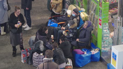 2022-Russian-invasion-of-Ukraine---Central-Railway-Station-in-Warsaw-during-the-refugee-crisis---a-group-of-women-and-children-with-their-belongings-sitting-on-the-floor