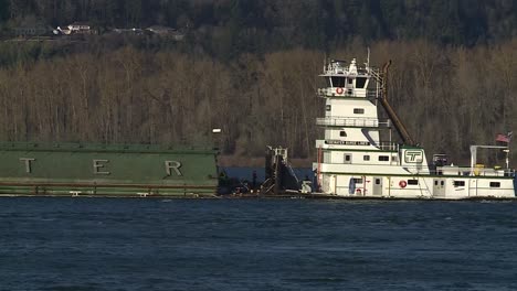 SLOW-MOVING-BARGE-MOVING-UP-THE-RIVER