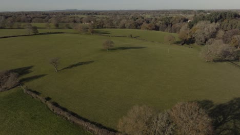 English-Countryside-Establishing-Shot-Green-Agricultural-Grass-Fields-Landscape-Aerial-View-Trees