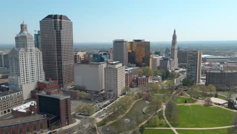Aerial-drone-shot-in-downtown-Hartford,-Connecticut,-featuring-the-financial-building-and-skyscrapers-in-the-sunny-afternoon