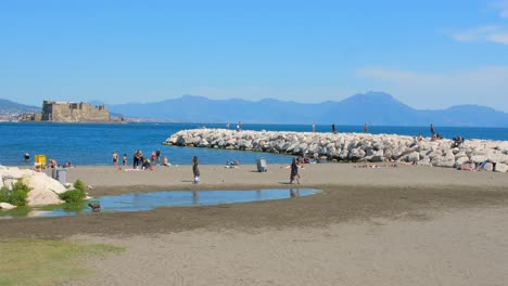 Several-Tourists-Relaxing-During-Summer-At-Mappatella-Beach-In-Italy