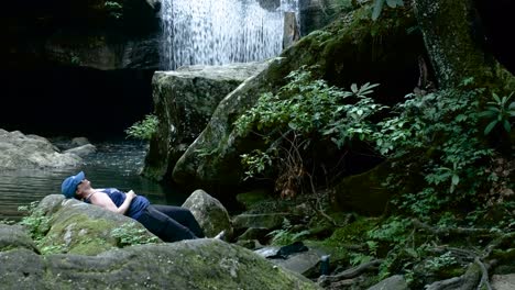 Wanderin-Entspannt-Sich-In-Der-Nähe-Eines-Wunderschönen-Wasserfalls