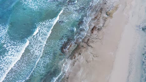 Aerial-top-view-of-Cyprus-beach-and-waves-hitting-sandy-coast