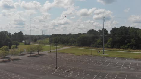 power-lines-invisibility-marker-balls-parking-lot-car-driving-road-forest-lake-industry-aerial-drone-ascending