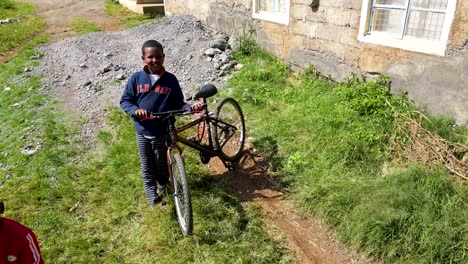 Aerial-drone-view-of-the-Africa-kids-playing-with-the-bicycles-during-school-holiday