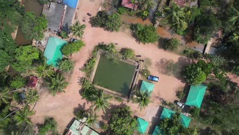 Aerial-view-of-pond-in-forest-countryside-in-Varkala,-Kerala
