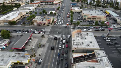 Aerial-view-of-a-SWAT-team-and-firefighters-crossing-a-busy-intersection-in-Los-Angeles,-USA