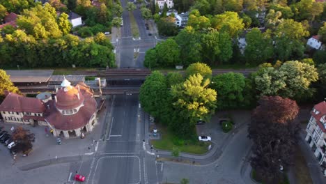 Yellow-S-Bahn-station-over-bridge-Beautiful-aerial-view-pursuit-flight-drone-footage-of-mexikoplatz-berlin-zehlendorf-golden-hour-Summer-2022-Cinematic-view-from-above-Tourist-Guide-by-Philipp-Marnitz