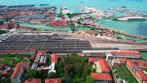 Aerial-Tour-of-Venice-Railway-Station-and-City-Center-Above-Canal