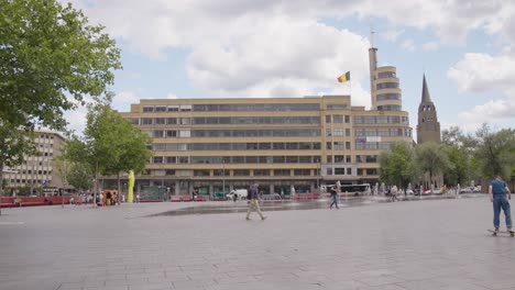 Belgian-flag-waving-on-top-the-Flagey-building-with-skaterboy-doing-trick-in-Ixelles---Brussels,-Belgium