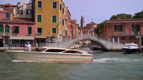 Bridge-And-Canal-Seen-From-A-Boat-During-Travel-In-Venice,-Italy---POV
