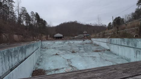 Slider-Footage-of-an-Abandoned,-Overgrown-Pool-at-the-Former-Fugates-Entertainment-Center-in-Eastern-Kentucky