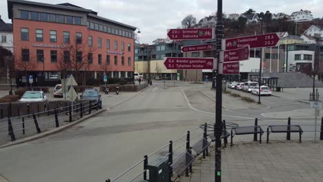 City-guidepost-sign-showing-bikeway-roads-and-distances-from-Arendal-city-center-Norway---Moving-gently-towards-and-passing-signs