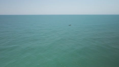 A-single-fishing-boat-among-vast-empty-sea