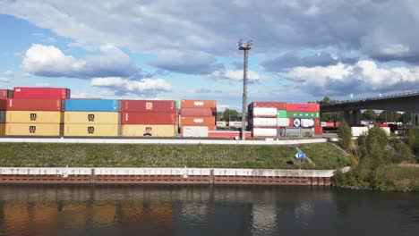Shot-from-the-river-of-rows-of-containers-in-the-international-cargo-port