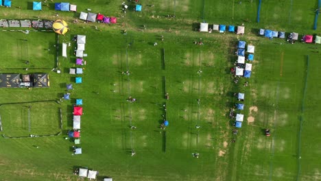 Top-down-aerial-of-sprawling-grass-volleyball-tournament