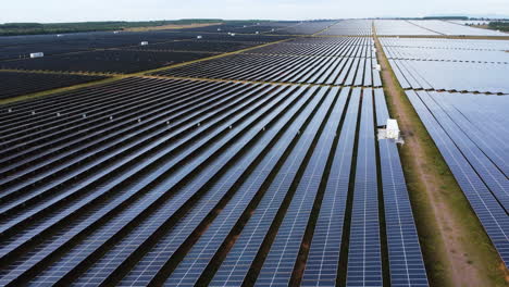 Aerial-panorama,-solar-panel-farm-field-generating-renewable-sustainable-energy