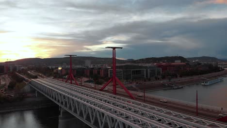 Slow-backward-dolly-aerial-of-Rákóczi-Bridge-and-a-train,-Budapest