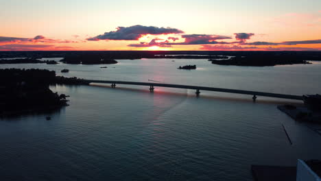 Aerial-view-overlooking-the-silhouettte-Lapinlahti-bridge,-in-Helsinki,-sunset-in-Finland