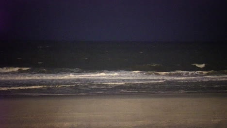 Night-beach-waves-gently-break-on-a-relaxing-shore