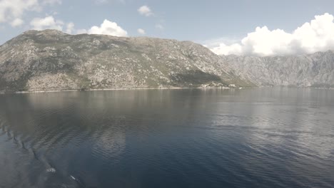 Static-POV-shot,-bypassing-a-mountains,-from-the-adriatic-sea,-on-a-sunny-day,-in-Kotor-city,-Montenegro