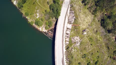 Overhead-Aerial-Drone-Shot-Following-a-Road-on-a-Seaside-Dam