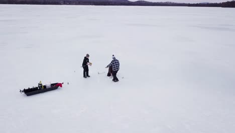 Get-an-aerial-view-of-Ice-Fishing-on-Fitzgerald-Pond,-Maine