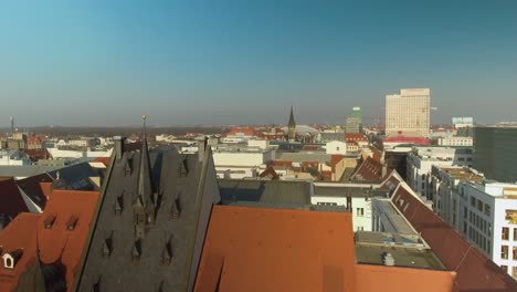 4K-Crane-Aerial-Drone-Shot-over-the-city-of-Leipzig,-Germany-in-the-afternoon-with-blue-sky