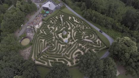 A-drone-shot,-flying-up-and-panning-down,-revealing-a-maze-in-the-Netherlands