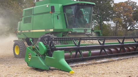 A-John-Deere-9600-Combine-driving-on-an-empty-soybeans-field-after-finished-harvesting