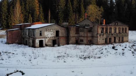 Flying-towards-abandoned-house-during-winter