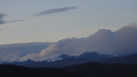 Time-lapse-of-clouds-moving-over-Bucegi-mountains,-filmed-with-high-zoom-from-distance