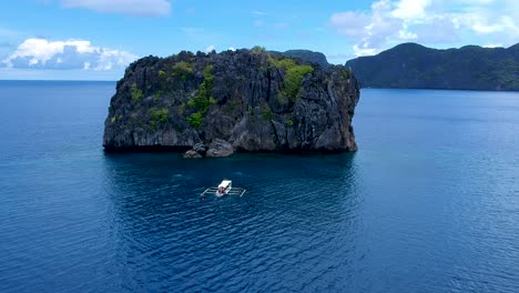 Aerial-view-of-dive-boat-by-North-rock-dive-site,-El-Nido,-Palawan,-Philippines