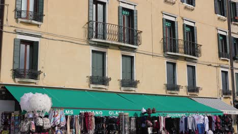 A-slow-wide-tilt-shot-revealing-an-Italian-building-with-front-shop-during-the-day