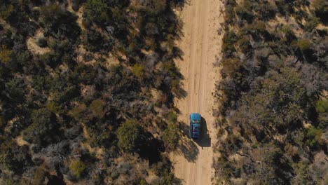 Car-drives-down-a-4x4-track-in-Western-Australia-Overhead-Aerial-Drone-Shot