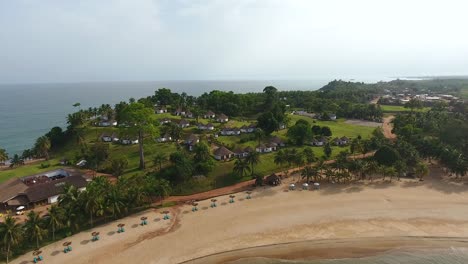 Closing-in-aerial-shot-of-a-beach-resort-beach-and-villas-in-Mermaids-Bay-in-Southwest-Ivory-Coast-San-Pedro-Africa