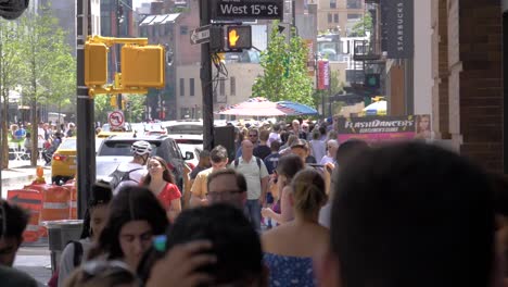 Crowd-and-traffic-at-the-entrance-of-Chelsea-Market,-West-15th-Street,-Manhattan,-New-York-City,-filmed-in-180-fps-slow-motion