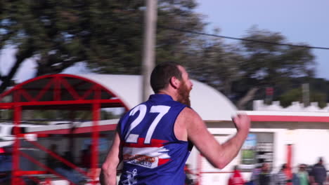 Austrian-rules-football-AFL-country-game-of-a-player-with-a-beard-kicking-a-goal-and-celebrating-with-his-team-mates