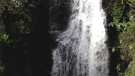 White-water-flowing-over-falls,-Natural-Bridge-Waterfall-Springbrook,-Queensland