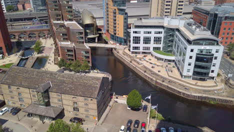 Right-to-Left-Pan-of-Granary-Wharf-in-Leeds,-UK-on-a-Sunny-Summer’s-Day-from-a-High-Vantage-Point-with-Canal---Pub-Garden-Visible