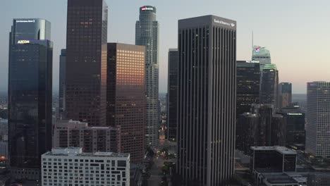 Aerial-push-shot,-drone-flying-towards-skyscrapers-of-the-financial-district,-downtown-of-Los-Angeles