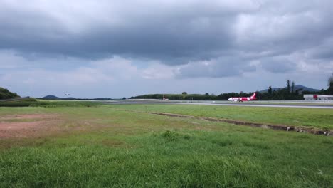 Landscape-view-of-the-airport-runway-while-silk-air-airplane-boeing737-landing-into-the-runway-in-cloudy-daytime--4k-UHD-video