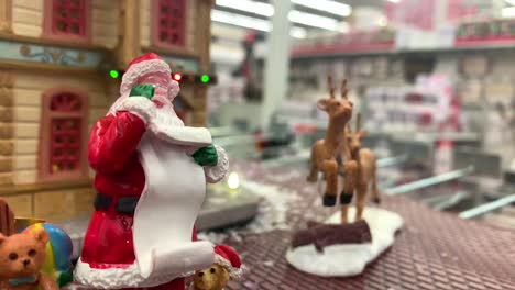 Christmas-Figurine-of-Santa-Clause-in-store-with-Christmas-decorations