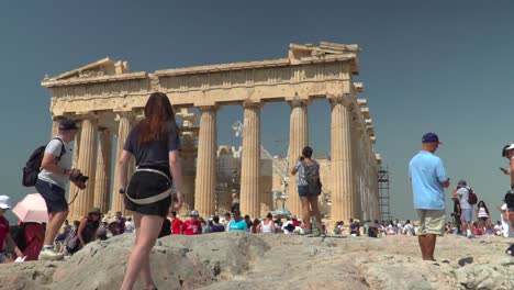 Masses-of-tourists-at-Akropolis-in-Greece,-taking-pictures-on-bright-day