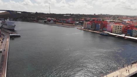 Sint-Anna-Bay-with-a-cruise-shipped-docked-in-the-harbour-in-Willemstad,-Curacao