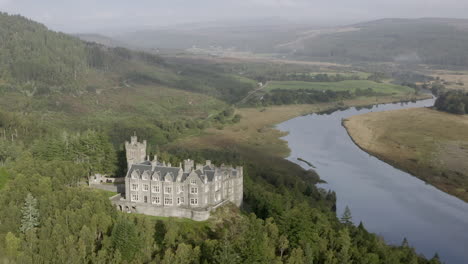 An-aerial-view-of-Carbisdale-Castle-on-a-sunny-morning-with-cloudy-skies