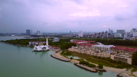 Aerial-wide-shot-of-big-melaka-city-beside-river,harbor-and-famous-mosque-on-bank