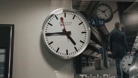 A-simple,-white-wall-clock-displayed-on-a-wall-of-a-watchmaker's-office---mid-shot