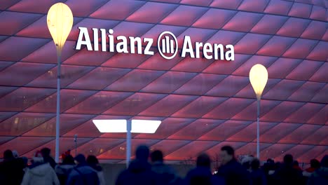 Fans-walking-to-Allianz-Arena,-home-stadium-of-famous-german-football-club-FC-Bayern-München-to-see-a-soccer-match