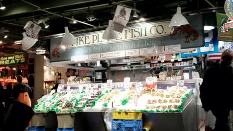 Pike-Place-Fish-Company-at-the-Public-Market-Center---Fishmongers-service-customers---known-for-famously-throwing-their-fresh-caught-fish-to-customers